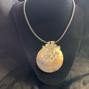 Silver necklace on leather strap